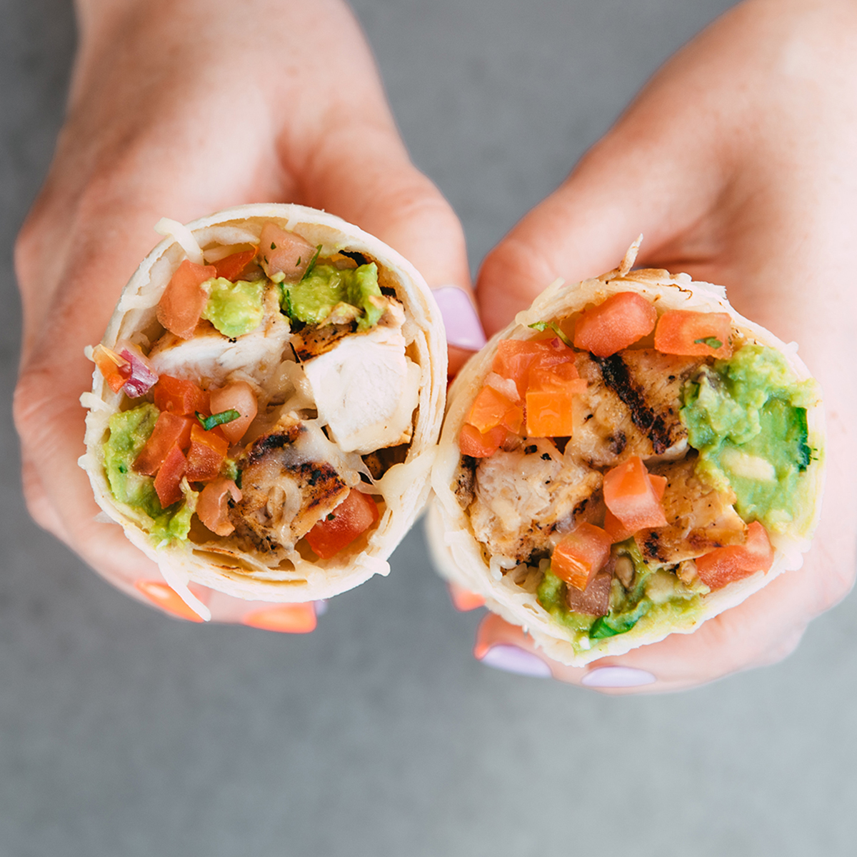 Hands holding burrito