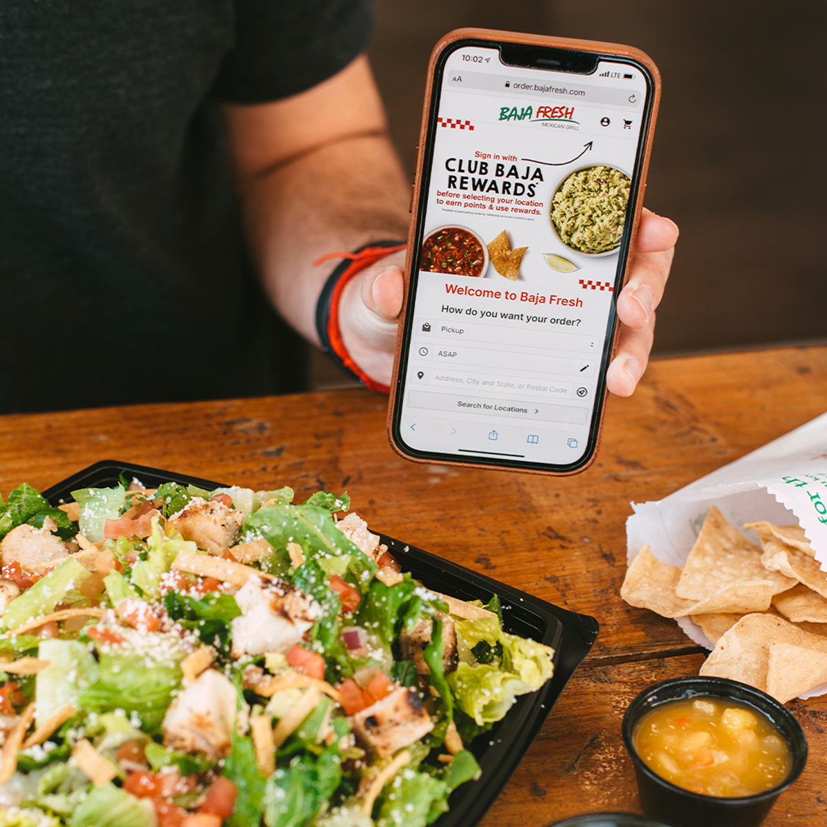 Food and phone showing Baja App